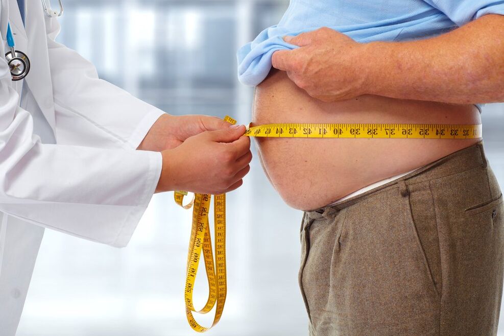 Doctor measuring patient's waistline while dieting